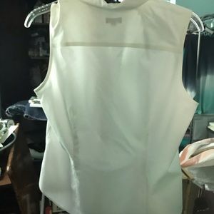 White sleeveless dressy sleeveless blouse.